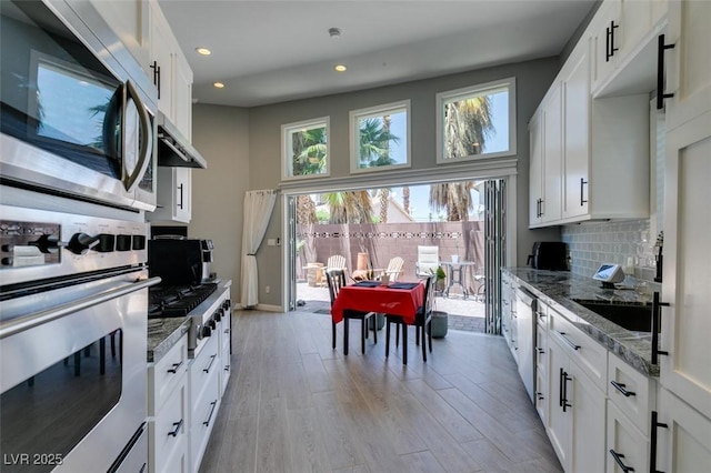 3708 Lorraine Ln, Las Vegas, NV 89120 - kitchen featuring appliances with stainless steel finishes, light wood-style floors, recessed lighting, light stone counters, and decorative backsplash