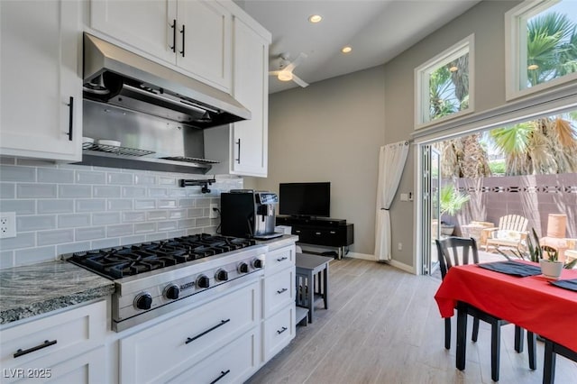 3708 Lorraine Ln, Las Vegas, NV 89120 - kitchen with stainless steel gas cooktop, under cabinet range hood, white cabinetry, and recessed lighting