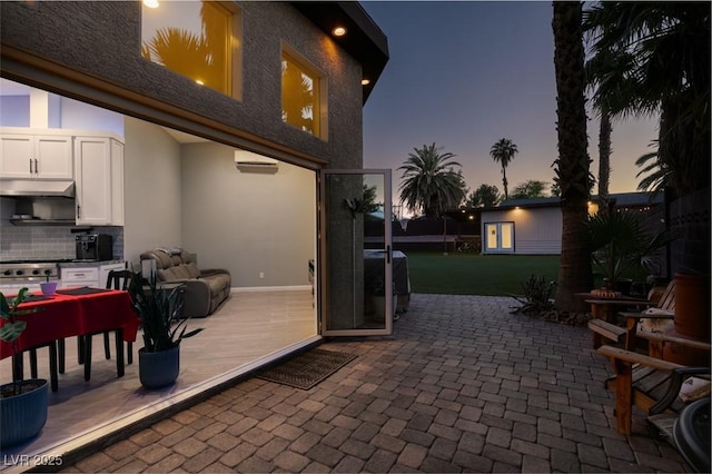 3708 Lorraine Ln, Las Vegas, NV 89120 - patio terrace at dusk featuring a patio and a wall unit AC