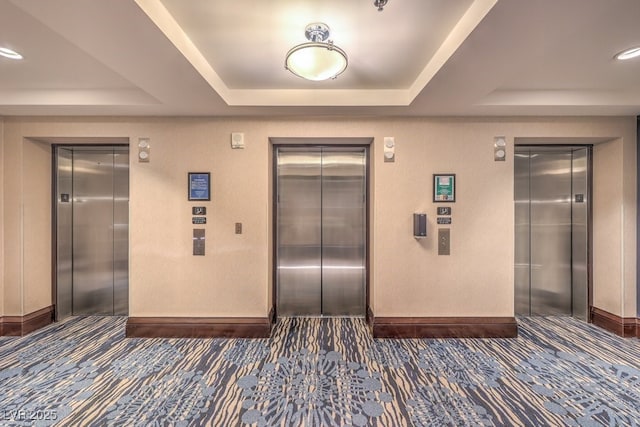211 E Flamingo Rd Unit 402, Las Vegas, NV 89169 - hallway featuring elevator and a tray ceiling
