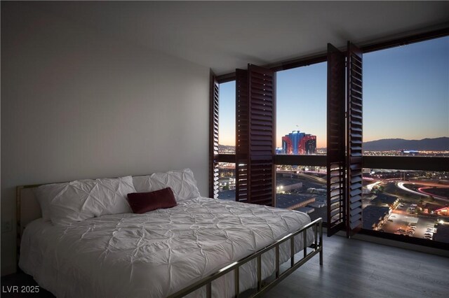 4471 Dean Martin Dr Unit 2406, Las Vegas, NV 89103 - bedroom with wood finished floors, a wall of windows, and a view of city