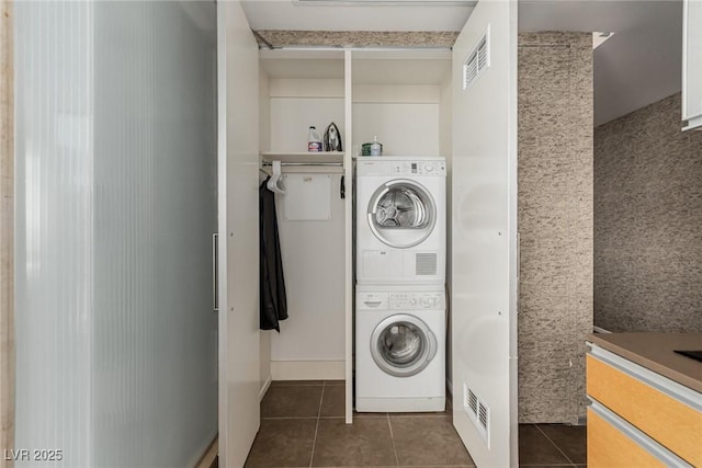 3722 Las Vegas Blvd Unit 3209, Las Vegas, NV 89158 - laundry area with stacked washer and clothes dryer and tile patterned flooring