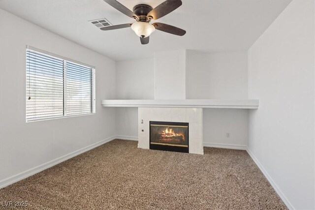 741 Wildwood Beach Ave, Henderson, NV 89052 - unfurnished living room with carpet, a tiled fireplace, and ceiling fan