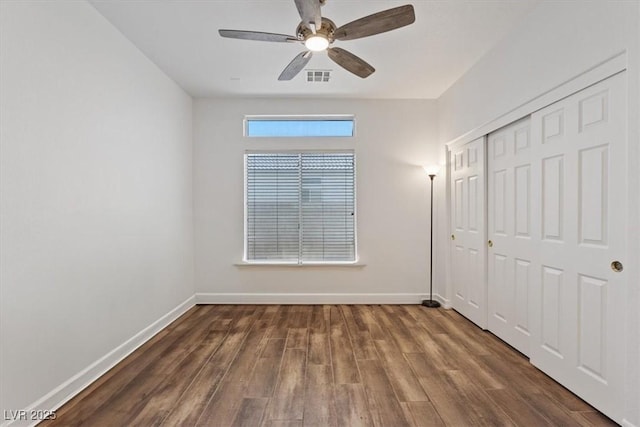 741 Wildwood Beach Ave, Henderson, NV 89052 - unfurnished bedroom with wood finished floors, a closet, and a ceiling fan
