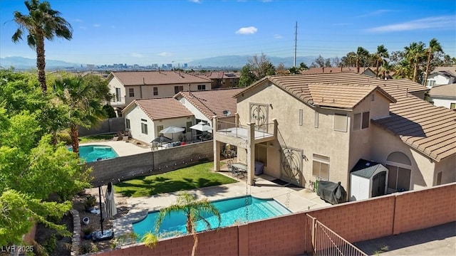 741 Wildwood Beach Ave, Henderson, NV 89052 - back of property with a fenced backyard, a balcony, stucco siding, a tiled roof, and a residential view