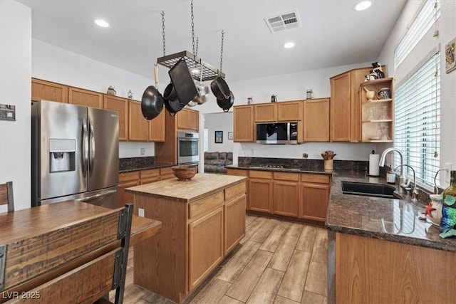 741 Wildwood Beach Ave, Henderson, NV 89052 - kitchen featuring stainless steel appliances, open shelves, wood counters, light wood-style flooring, and a center island