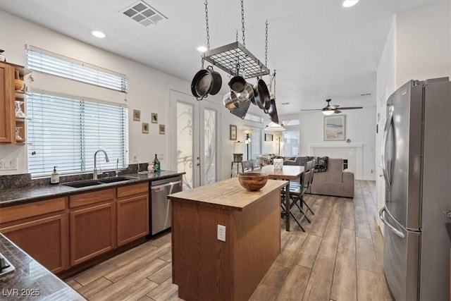 741 Wildwood Beach Ave, Henderson, NV 89052 - kitchen with stainless steel appliances, open floor plan, ceiling fan, butcher block countertops, and light wood-type flooring