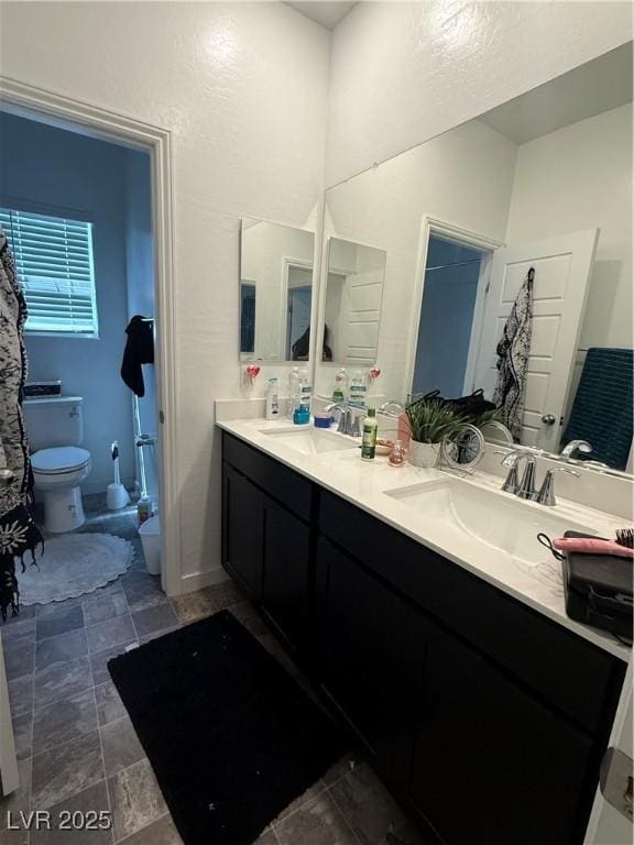 1618 Dakota Group Ave, North Las Vegas, NV 89084 - bathroom featuring double vanity and toilet