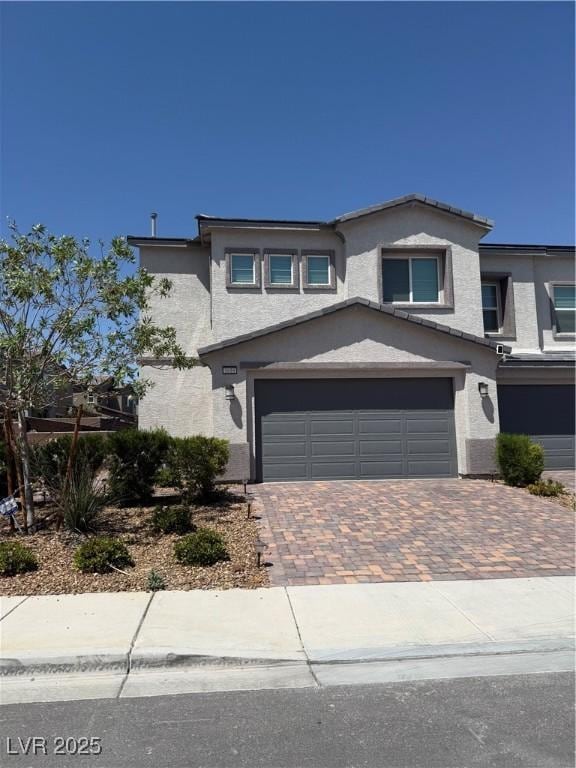 1618 Dakota Group Ave, North Las Vegas, NV 89084 - view of front of home with decorative driveway, stucco siding, and an attached garage