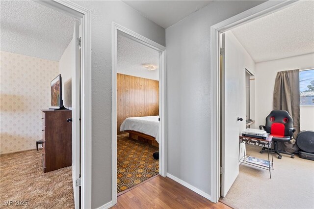 585 W Ingram Ave, Overton, NV 89040 - corridor featuring a textured ceiling, wood finished floors, carpet flooring, and a desk