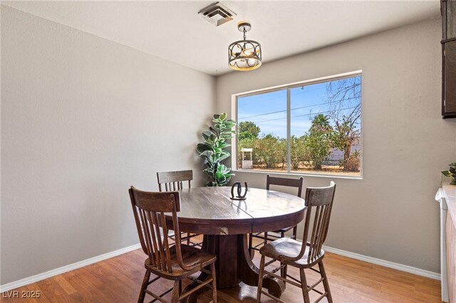 585 W Ingram Ave, Overton, NV 89040 - dining room featuring wood finished floors and a chandelier