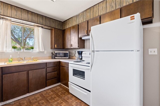585 W Ingram Ave, Overton, NV 89040 - kitchen featuring white appliances, light countertops, and dark brown cabinetry