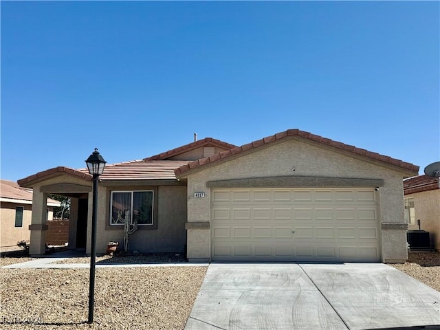 4837 River Splash Ave, Las Vegas, NV 89131 - ranch-style house with a tiled roof, concrete driveway, stucco siding, and a garage