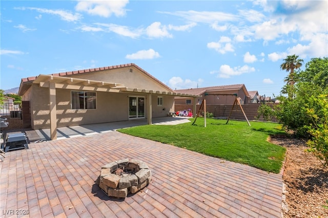 4837 River Splash Ave, Las Vegas, NV 89131 - rear view of property with a playground, an outdoor fire pit, stucco siding, a patio area, and a fenced backyard