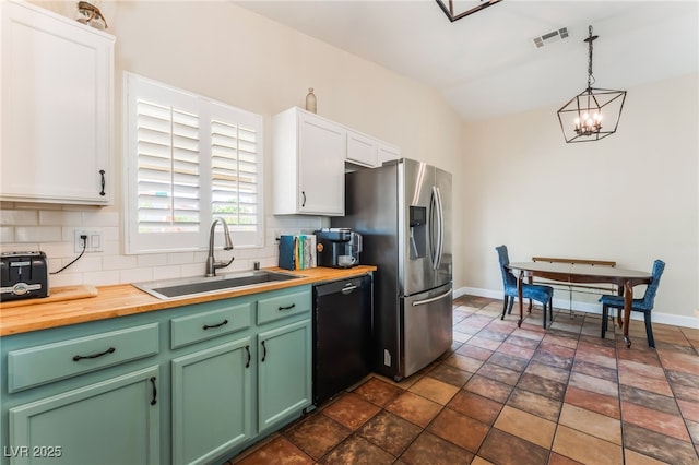 4837 River Splash Ave, Las Vegas, NV 89131 - kitchen with black dishwasher, butcher block countertops, backsplash, white cabinetry, and lofted ceiling