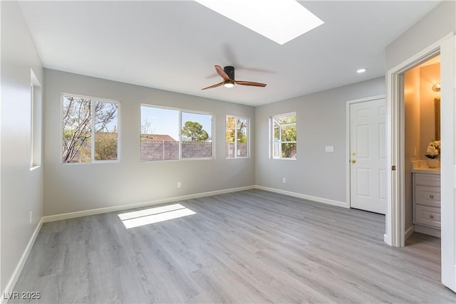 5800 Auborn Ave, Las Vegas, NV 89108 - unfurnished bedroom featuring light wood-type flooring, a skylight, recessed lighting, ceiling fan, and connected bathroom