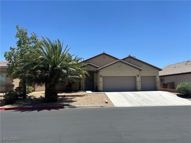4620 Ventana Rey St, North Las Vegas, NV 89081 - view of front of property featuring a garage, concrete driveway, stucco siding, and a tiled roof