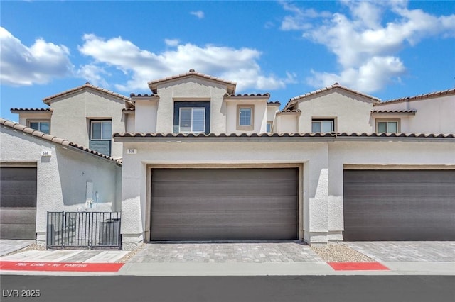 530 Sonoma Range St, Las Vegas, NV 89138 - mediterranean / spanish home with stucco siding, a tiled roof, decorative driveway, and a garage
