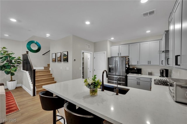 530 Sonoma Range St, Las Vegas, NV 89138 - kitchen featuring stainless steel fridge with ice dispenser, a peninsula, light wood-style flooring, a breakfast bar, and recessed lighting