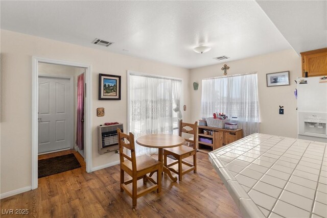 2730 Banyon St, Pahrump, NV 89048 - dining room with heating unit and wood finished floors