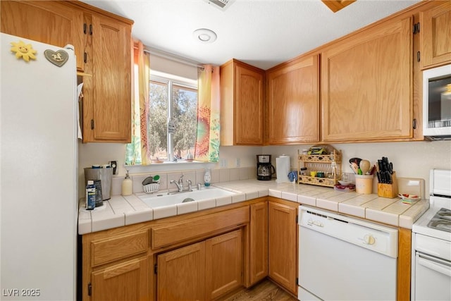 2730 Banyon St, Pahrump, NV 89048 - kitchen with white appliances, light countertops, and light wood-style flooring