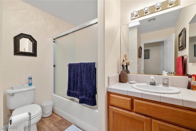 2730 Banyon St, Pahrump, NV 89048 - bathroom with vanity, shower / bath combination with glass door, and wood finished floors
