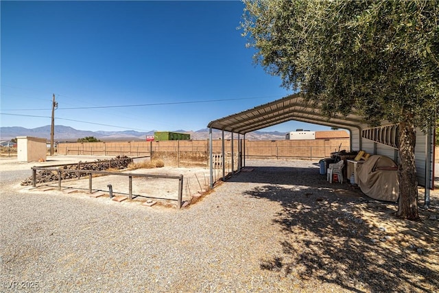 2730 Banyon St, Pahrump, NV 89048 - view of yard with a carport, a mountain view, and an outbuilding