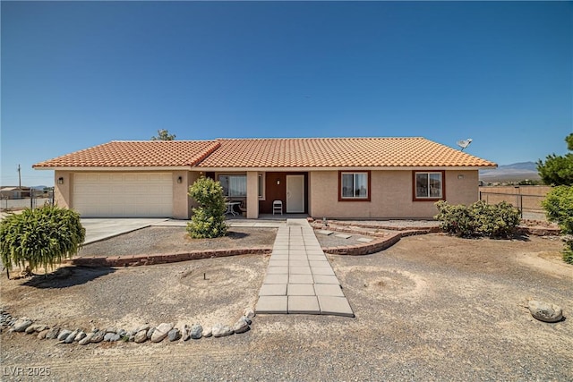 2730 Banyon St, Pahrump, NV 89048 - ranch-style house with stucco siding, an attached garage, a tile roof, covered porch, and concrete driveway