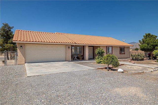 2730 Banyon St, Pahrump, NV 89048 - view of front of home with concrete driveway, stucco siding, a garage, and a tile roof