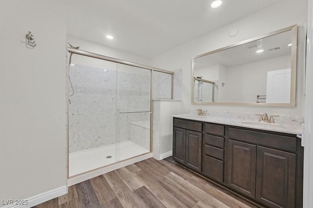 9327 Ettrick Ct, Las Vegas, NV 89178 - full bath featuring double vanity, a shower stall, wood finished floors, and recessed lighting