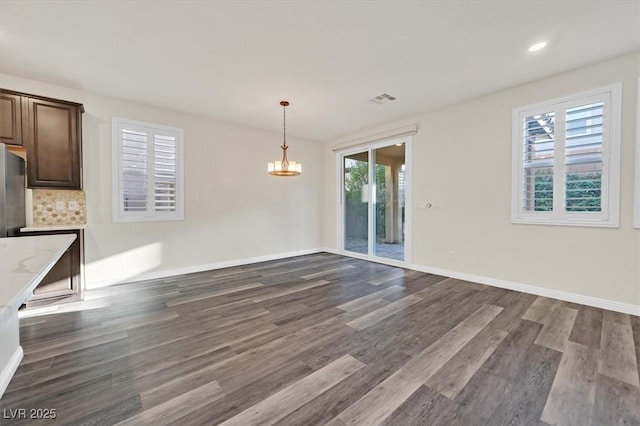 9327 Ettrick Ct, Las Vegas, NV 89178 - unfurnished dining area with dark wood finished floors, a chandelier, and recessed lighting