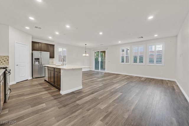 9327 Ettrick Ct, Las Vegas, NV 89178 - kitchen featuring appliances with stainless steel finishes, light wood finished floors, light countertops, and recessed lighting
