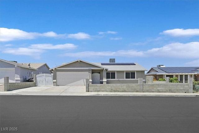 808 Vermillion Dr, Henderson, NV 89002 - ranch-style home with a gate, roof mounted solar panels, a garage, driveway, and stucco siding