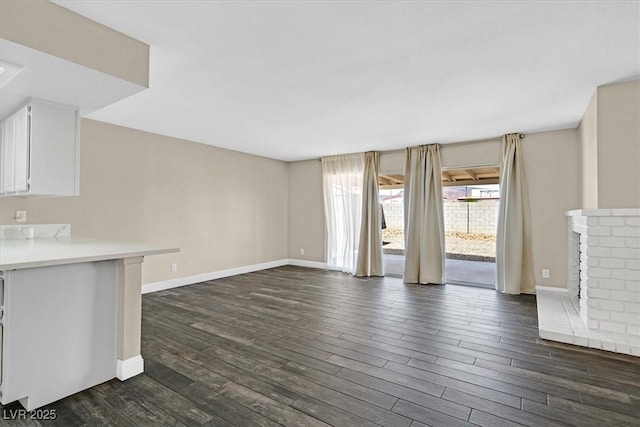 808 Vermillion Dr, Henderson, NV 89002 - unfurnished living room with dark wood finished floors and baseboards