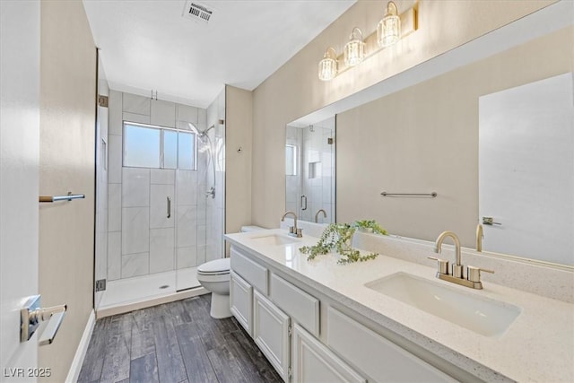 808 Vermillion Dr, Henderson, NV 89002 - bathroom with a stall shower, double vanity, and wood finished floors