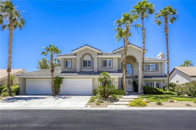 9905 Fox Springs Dr, Las Vegas, NV 89117 - view of front of property with stucco siding, concrete driveway, a chimney, and a garage