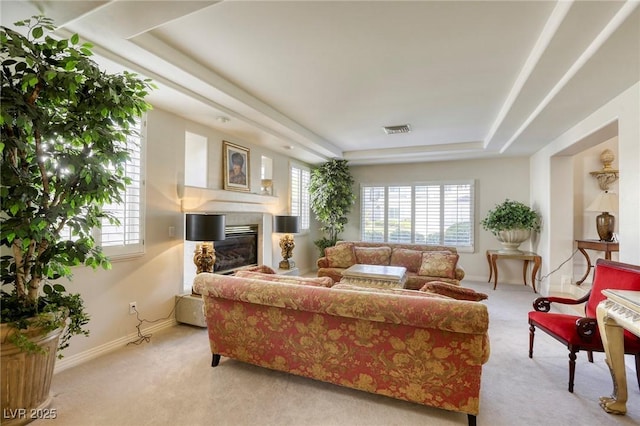 9905 Fox Springs Dr, Las Vegas, NV 89117 - carpeted living area featuring a tray ceiling and a glass covered fireplace