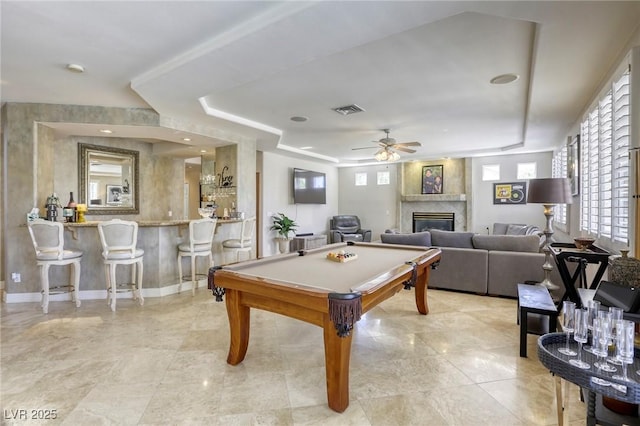 9905 Fox Springs Dr, Las Vegas, NV 89117 - game room featuring a tray ceiling, billiards, a glass covered fireplace, a ceiling fan, and light tile patterned floors