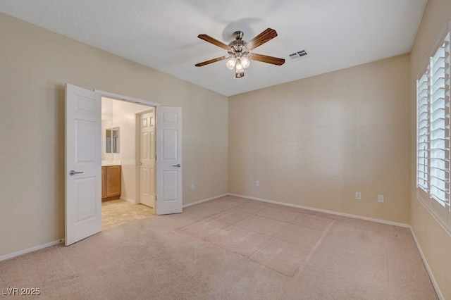 7916 Lyrebird Dr, North Las Vegas, NV 89084 - unfurnished bedroom featuring light colored carpet, ensuite bath, and ceiling fan