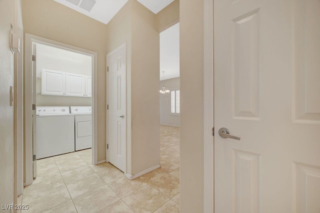 7916 Lyrebird Dr, North Las Vegas, NV 89084 - hallway with independent washer and dryer, light tile patterned floors, and a chandelier