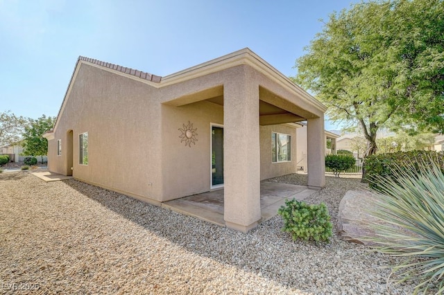 7916 Lyrebird Dr, North Las Vegas, NV 89084 - view of home's exterior featuring stucco siding and a patio area