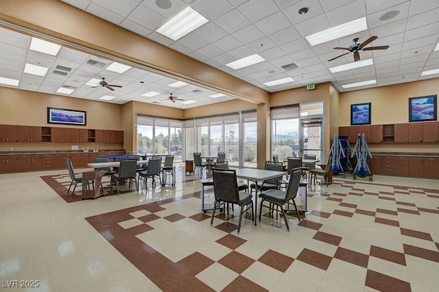 7916 Lyrebird Dr, North Las Vegas, NV 89084 - dining room with a drop ceiling, a ceiling fan, and light floors