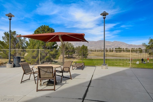 7916 Lyrebird Dr, North Las Vegas, NV 89084 - view of patio / terrace featuring a mountain view and outdoor dining area
