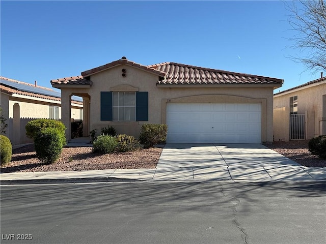 338 Brilliant Summit Cir, Henderson, NV 89052 - mediterranean / spanish home featuring a garage, stucco siding, driveway, and a tiled roof