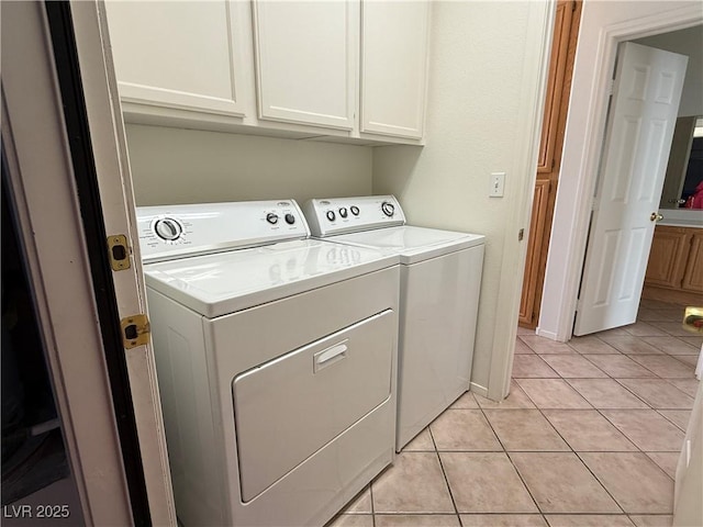 338 Brilliant Summit Cir, Henderson, NV 89052 - laundry area featuring cabinet space, washer and clothes dryer, and light tile patterned floors