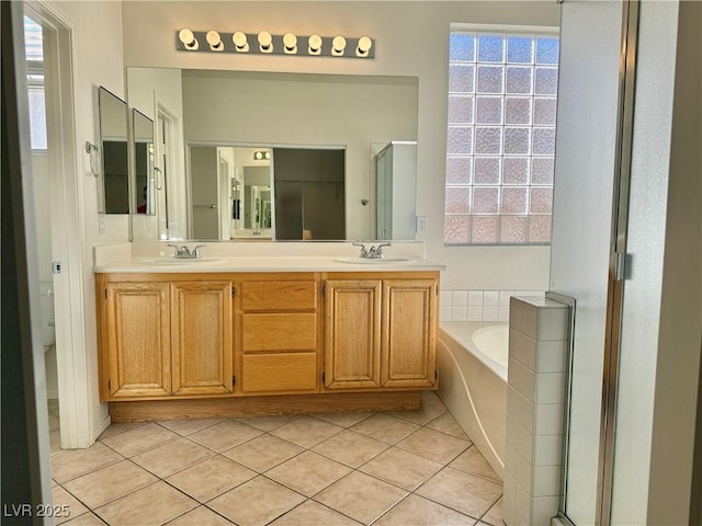 338 Brilliant Summit Cir, Henderson, NV 89052 - full bathroom featuring tile patterned floors, a garden tub, double vanity, and plenty of natural light