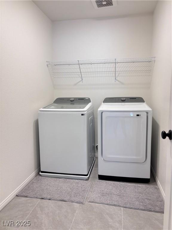 4993 Birchland Manor Ave, Las Vegas, NV 89139 - laundry area with washer and clothes dryer and baseboards