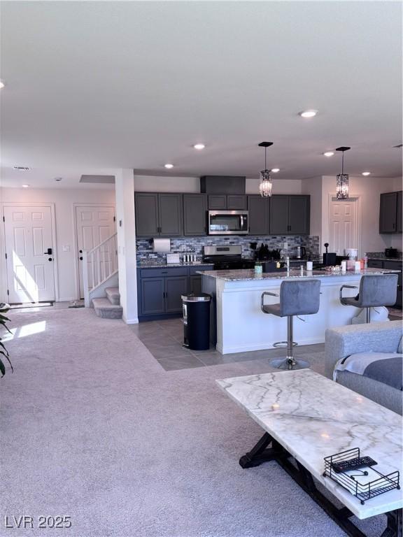 4993 Birchland Manor Ave, Las Vegas, NV 89139 - living area featuring recessed lighting, light colored carpet, and stairs