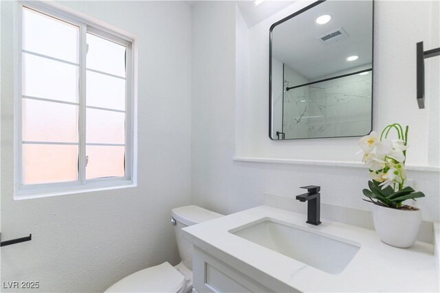 1916 Howard Ave, Las Vegas, NV 89104 - full bath with healthy amount of natural light, vanity, a marble finish shower, and recessed lighting