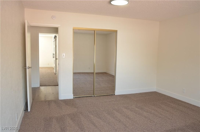 4277 Rimcrest Rd, Las Vegas, NV 89121 - unfurnished bedroom featuring carpet, a closet, and a textured ceiling